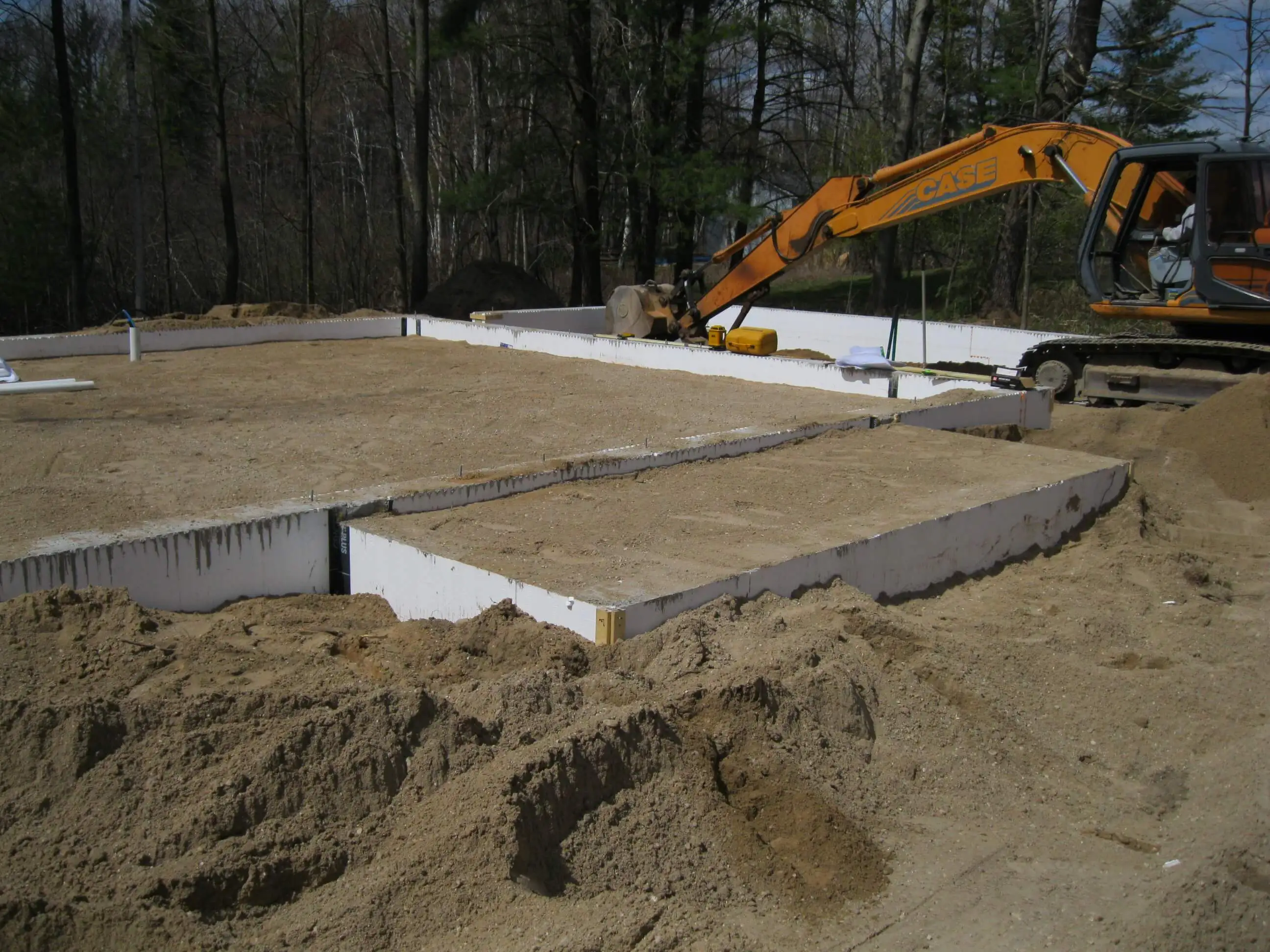 Construction workers backfilling a trench, ensuring proper soil compaction