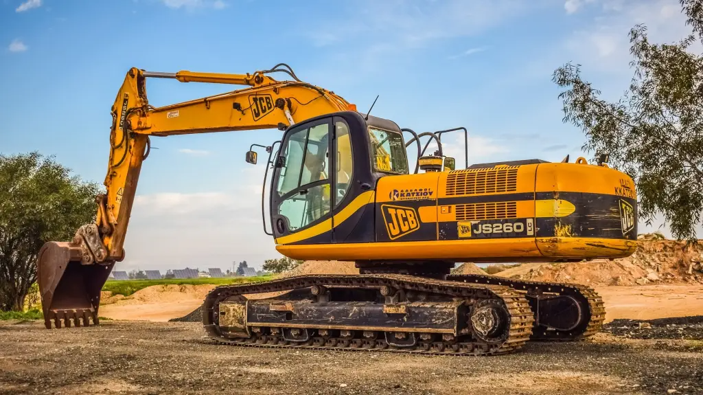 Heavy machinery clearing a construction lot, preparing the land for development