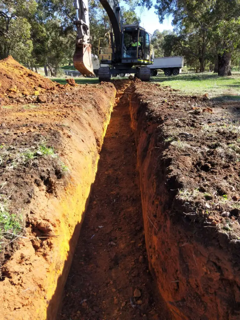 Excavator digging a trench for utility installation or foundation work